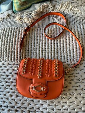 La Carrie Orange Leather Crossbody Bag with Gold Chain Accents and hardware